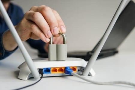 high-speed-wi-fi-router-with-lock-man-using-lapto-2024-10-11-13-48-14-utc.jpg